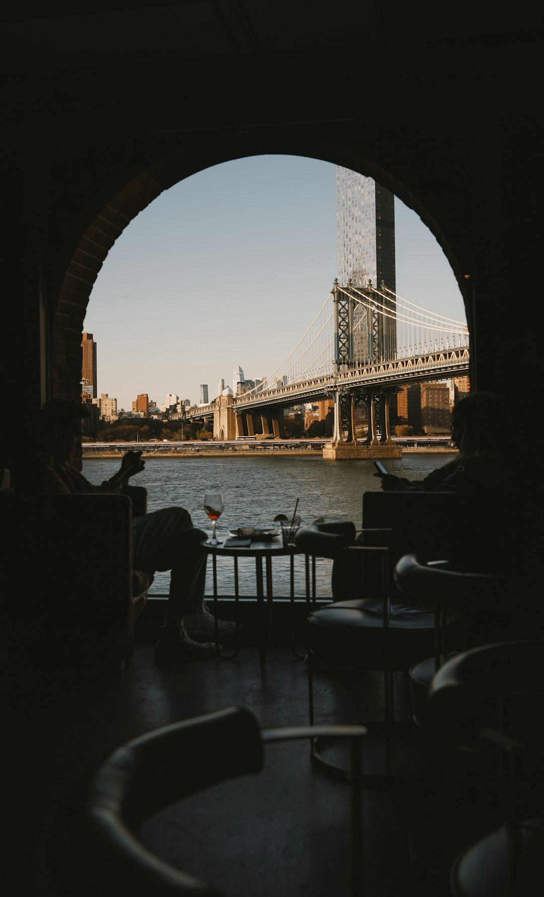 A view of a bridge through an arch in a building